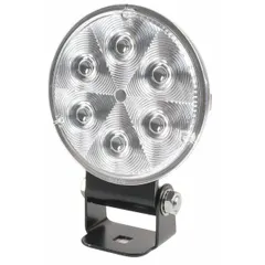This GROTE flood-type LED work light features a black housing and a removable bracket for universal surface-mount installation. It uses a hard shell connector for electrical connection. Typical applications include providing broad-area illumination on trucks, trailers, and heavy equipment for maintenance, construction, or off-road tasks.