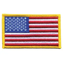 Embroidered emblem featuring a U.S. Flag design. Measures 3 3/8 inches by 2 inches. Constructed of polyester and rayon with a gold border. Equipped with a hook fastener for attachment to fabric surfaces. Commonly used on uniforms, bags, and apparel for identification or decoration.