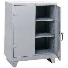 This welded steel cabinet with gray powder-coated finish includes two adjustable shelves and a swing handle with padlock hasp for secure storage. The 14 ga panel thickness and legs provide stability in industrial environments. Suitable for organizing tools, parts, and equipment in warehouses, factories, and workshops.
