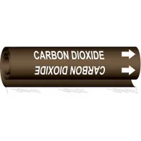 Wrap-around pipe marker for identifying carbon dioxide piping. Brown background with white legend text reading 'Carbon Dioxide' and directional arrows. Fits pipe outer diameters from 1/2 to 1-3/8 inches. Single marker included