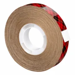 This reverse-wound adhesive transfer tape features a permanent acrylic adhesive on a transparent, UV-resistant carrier with a kraft paper liner. It is 1/2 inch wide, 18 yards long, and 5 mil thick. Used for mounting, splicing, and laminating where a clean, invisible bond is required on various substrates.