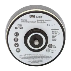This threaded-shank sanding disc backing pad has a 5-inch diameter and 1-1/4-inch thickness with a 5/16"-24 threaded-shank tool connection. It is a non-vacuum, soft-density pad designed for use with pressure-sensitive adhesive discs in surface finishing applications on metal, wood, or composites.