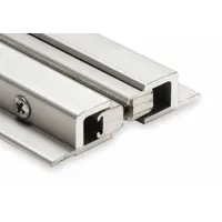 This door astragal seals the gap between paired doors or a door and frame to block drafts, light, and pests. It features an aluminum flange and a polypropylene brush insert. Typical applications include commercial and industrial door assemblies where weather sealing is required