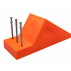 Orange plastic pipe chock used to secure pipes and cylindrical loads during transport or storage, preventing rolling. Overall length 8 in, width 3 in, height 3-1/2 in. Suitable for material handling and industrial applications.