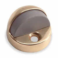 Floor-mounted dome door stop made of brass. Width 1 13/16 in, overall height 1 1/2 in. Used to limit door swing and protect walls in commercial or industrial settings