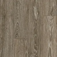 This vinyl floor tile from the American Charm LVT line features a Charlestown Oak pattern in Emberglow Brown. The tile has a smooth surface and measures 6 inches in width. It is suited for residential and light-commercial flooring applications such as living areas, kitchens, and retail spaces