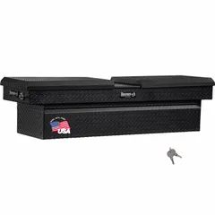This crossover box features a gull wing lid design for convenient access to stored items. Constructed of aluminum with a matte black finish, it measures 71 inches in overall width. Suitable for mounting in pickup truck beds to organize and secure tools and equipment.