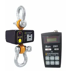 Steel-housed dynamometer with IP65 rating, wireless remote display, and RS-232 data outlet. Measures tension forces in pounds with 5 kg readability. Includes load cell, calibration certificate, and carrying case. Used for load testing and weight verification in lifting and material handling operations.