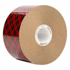 This reverse-wound adhesive transfer tape features a permanent-bond acrylic adhesive on a kraft paper liner. The transparent tape is 2 mils thick, 2 inches wide, and 60 yards long per roll, supplied in a 24-pack. It is used for mounting, splicing, and bonding applications such as assembly, gasketing, and nameplate attachment.