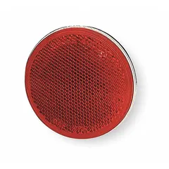 Round red acrylic stick-on reflector, 3 inches in diameter, meeting FMVSS standards. Used for vehicle safety marking on trailers, trucks, and equipment requiring compliant conspicuity lighting.
