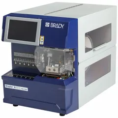 Desktop wraparound label printer and applicator with 300 dpi printhead resolution, capable of up to 7,000 labels per day. Includes Brady Workstation software, Wrap-4-417 pre-installed label material, and R4302 ribbon. Used for applying durable labels to wires, cables, and small-diameter pipes in industrial settings.