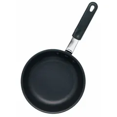 This 7 1/2-inch diameter fry pan features an aluminum body with a black non-stick coating and a steel riveted handle. NSF certified for commercial foodservice use, it is suitable for cooking eggs, pancakes, and other delicate foods in high-volume kitchens.