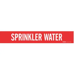 Red adhesive pipe marker with white legend reading 'Sprinkler Water'. Fits pipe outer diameters from 2-1/2 to 7-7/8 inches. Supplied without arrows. Used to identify sprinkler water lines in piping systems.