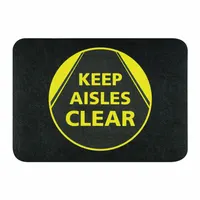 This polypropylene floor mat measures 24 inches by 17 inches and is 1/8 inch thick. It features an adhesive backing for secure placement on indoor floors. The black mat is used to designate walkways and aisles, helping to maintain clear pedestrian paths and support workplace safety