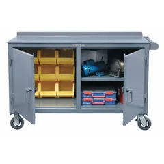 This mobile cabinet bench from STRONG HOLD provides a heavy-duty work surface with integrated shelving for storage. Fully assembled with a steel frame and gray finish, it supports up to 4800 lb overall load. The side handle enables easy repositioning within industrial workshops or garages for organizing tools, machinery, and parts.