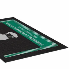 This 3 ft x 5 ft polypropylene entrance mat with adhesive backing marks the location of an emergency eye wash station. The 1/8 in thick mat is designed for placement at facility entrances or near safety equipment to guide personnel during emergencies.