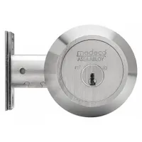 This MEDECO standard cylindrical deadbolt features a conventional core cylinder with a Schlage C keyway and a satin chromium-plated finish. Designed for doors up to 2-1/2 inches thick, it includes the core and is suitable for commercial or institutional interior or exterior applications where ligature resistance and ADA compliance are not required