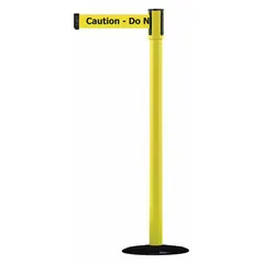This retractable belt post barrier from TENSABARRIER features a yellow cast iron base and metal alloy post. The black belt extends to 7 1/2 ft and displays yellow 'Caution Do Not Enter' text. Used to cordon off restricted areas and manage pedestrian traffic in industrial, warehouse, and public settings.