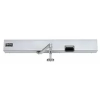 This heavy-duty low energy door operator from the 7100SZ series is designed for automatic door opening in limited-traffic interior/exterior applications. It features a non-hold open closer type, aluminum painted finish, and is powered by 24 VDC. The unit is ADA compliant and suitable for use in commercial buildings and accessible entrances