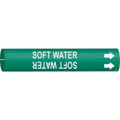 This snap-on pipe marker identifies soft water lines in piping systems. It features a green background with white legend text and directional arrows. Designed to fit pipe outer diameters from 2-1/2 to 3-7/8 inches. Suitable for use in industrial facilities for clear pipe identification.