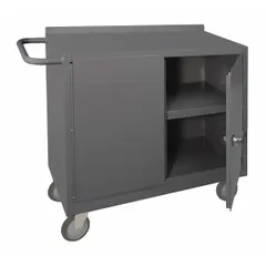 This mobile cabinet bench is constructed from steel with a gray finish. It is fully assembled and includes a handle on the side for mobility. The unit has an overall load capacity of 1,200 lb. Suitable for use in industrial environments as a mobile work surface and storage solution for tools and parts.