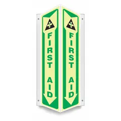 V-shaped projection first aid sign made of PETG, 18 in x 7 1/2 in nominal size, 0.07 in thick. Features mounting holes for installation and is glow-in-the-dark for visibility in low-light conditions. Not retroreflective.