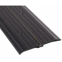 This 3 ft aluminum saddle threshold features a fluted transition surface. It is used to seal the gap beneath doors, reducing drafts, moisture, and pest entry in commercial and industrial doorways