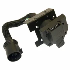 Plastic 7-way blade trailer wiring adapter for connecting a trailer plug to a vehicle's electrical system. Includes mounting hardware for secure installation. Used in fleet and vehicle maintenance for lighting and brake signal connections.
