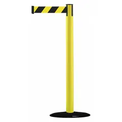 This retractable belt post barrier features a yellow plastic post with a chevron pattern and a black/yellow belt without legend. The cast iron base provides stability for crowd control and pedestrian guidance in industrial and public areas. Belt length is 7 1/2 ft.