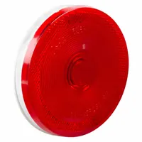 Incandescent stop light with a red round lens and 4 5/16 in overall diameter. Features a male pin electrical connection and grommet mount for permanent installation. Complies with FMVSS 108 standards. Used on trucks, trailers, and heavy equipment for brake and turn signaling