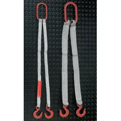 Two-leg bridle web sling with protected-edge construction for lifting loads with sharp edges. Type X sling made of polyester, 1 ply, 6 ft length, 1 in width, 8 1/2 in eye length. Silver color. Suitable for industrial rigging and material handling applications.