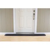 This black rubber ramp provides a smooth transition over door thresholds for wheelchairs, carts, and foot traffic. It is ADA compliant and measures 82 inches in length. Suitable for use in commercial buildings, warehouses, and public entrances