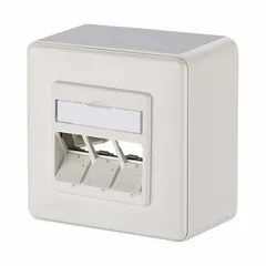 Surface-mount wall outlet with a zinc die-cast (GD-Zn) housing, designed to accept individual keystone modules. Features a 45° mounting angle and white finish. Supplied unequipped, without connector. Suitable for structured cabling installations in office, industrial, or residential environments.