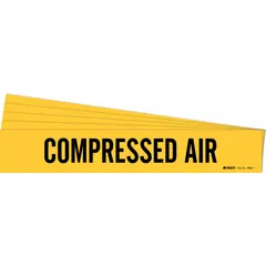 Yellow adhesive pipe marker with black legend reading 'Compressed Air' for identifying piping systems. Fits pipe outer diameters from 2-1/2 to 7-7/8 inches. Sold in a 5-pack without directional arrows. Applied directly to pipe surfaces in industrial facilities for clear line identification.