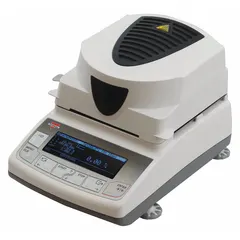 Oven-type moisture analyzer with 60 g capacity and 0.001 g readability. Temperature range 0°C to 160°C. Interfaces: PS2, RS232C, USB. LCD display. Moisture measurement repeatability 0.100 % to 1.000 %. Suitable for determining moisture content in solid or semi-solid samples in laboratory settings.