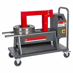 Portable induction bearing heater from the SBH series with a cross-bar design. Operates at 480V and 24 A. Accommodates bearings with a 1 3/16 in bore for thermal expansion before installation. Suitable for maintenance and assembly tasks in industrial settings.
