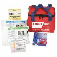 This portable first aid kit is housed in a red fabric case and serves up to 25 people. It contains 32 components including a trauma pad, five knuckle bandages, and eyewash, with no oral or inhalant medication. Designed for industrial settings, it meets OSHA compliance requirements for treating minor injuries