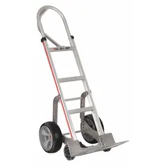Single-loop hand truck with silver aluminum frame and flat-free tires. Designed for moving boxes, appliances, and equipment in warehouses and industrial facilities. Ergonomic tilt-back operation reduces strain during transport.