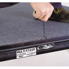 Steel modular stage system with carpeted surface, adjustable height up to 2.3 ft. Includes 100 decks covering 40 ft by 40 ft. Suitable for temporary event staging, performances, and presentations.