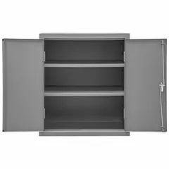 This industrial shelf cabinet features a welded steel frame with a powder-coated gray finish. It includes two adjustable shelves and a swing handle with keyed lock for secure storage. The 16 ga panel thickness provides structural rigidity. Suitable for organizing tools, parts, and equipment in warehouses, factories, and maintenance shops.
