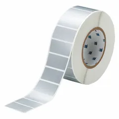 Precut label rolls with tamper-indicating adhesive that leaves a VOID pattern on the surface upon removal. Each label measures 1 in x 2 in with a 1 in core, finished in silver matte. Suitable for asset security and tamper evidence in industrial settings.