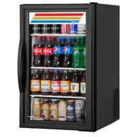 This TRUE REFRIGERATION countertop freezer merchandiser features a black exterior and glass door, with dimensions 33 1/2 in x 20 1/2 in x 26 3/8 in. It uses R-290 refrigerant and is designed for displaying frozen products in retail or foodservice settings