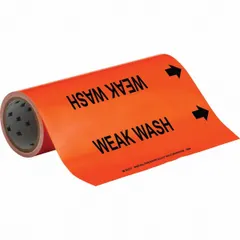 Orange adhesive pipe marker with black legend reading 'Weak Wash' and directional arrows. Designed for pipe outer diameters from 2-1/2 to 6 inches. Supplied on a roll containing 30 markers for identifying weak wash piping systems in industrial facilities.