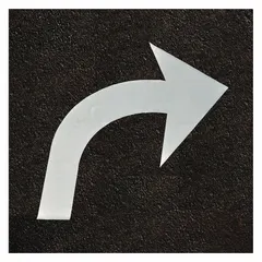 Pressure-sensitive adhesive pavement tape for marking directional arrows on asphalt or concrete surfaces. White Right Curve Arrow legend, 73 inches wide by 2 5/8 yards long per roll, supplied in a 4-pack. Used for traffic lane guidance in parking lots, warehouses, and industrial facilities.