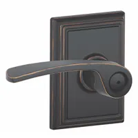 This privacy lever lockset is designed for interior doors requiring locking from the inside, such as bathrooms or bedrooms. It features a Merano style lever with an Aged Bronze and Brass finish. The ANSI F76 function allows locking via a turn button on the interior. Not ADA compliant or ligature-resistant