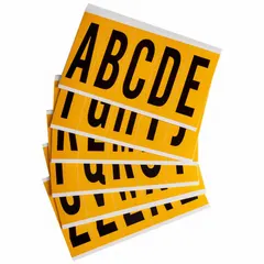 Black Gothic letters A to Z on a yellow background, designed for indoor/outdoor non-reflective use. Character height 3-7/8 in. Not self-spacing or aligning. Suitable for labeling equipment, bins, panels, and other industrial identification needs.