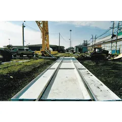 Fiberglass railroad track pan designed to contain spills from outrigger legs during crane or excavator operations. Measures 20 ft x 30 in x 4 in with a 125 gal spill capacity. Helps industrial sites meet environmental compliance.