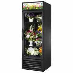This commercial floral refrigerator from TRUE REFRIGERATION features a black swing door and two adjustable shelves. It is designed to preserve cut flowers and floral arrangements at controlled temperature and humidity, suitable for use in florist shops, grocery stores, and event venues. The unit uses R-290 refrigerant and measures 78 5/8 x 27 x 29 7/8 inches.