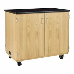 This mobile cabinet is constructed of wood and designed for storing and charging microscopes. It measures 4 ft wide by 30 in deep by 42-1/2 in high, with no drawers. The cabinet provides a dedicated surface for multiple microscopes and cord management in laboratory or educational settings.