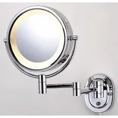 This wall-mounted makeup mirror features a glass mirror with 5X magnification and front lighting for shadow-free visibility. The metal frame has a chrome finish and polished edge. Overall dimensions: 13 in height, 10 in width, 4 in depth. Suitable for bathrooms, dressing rooms, or salons.